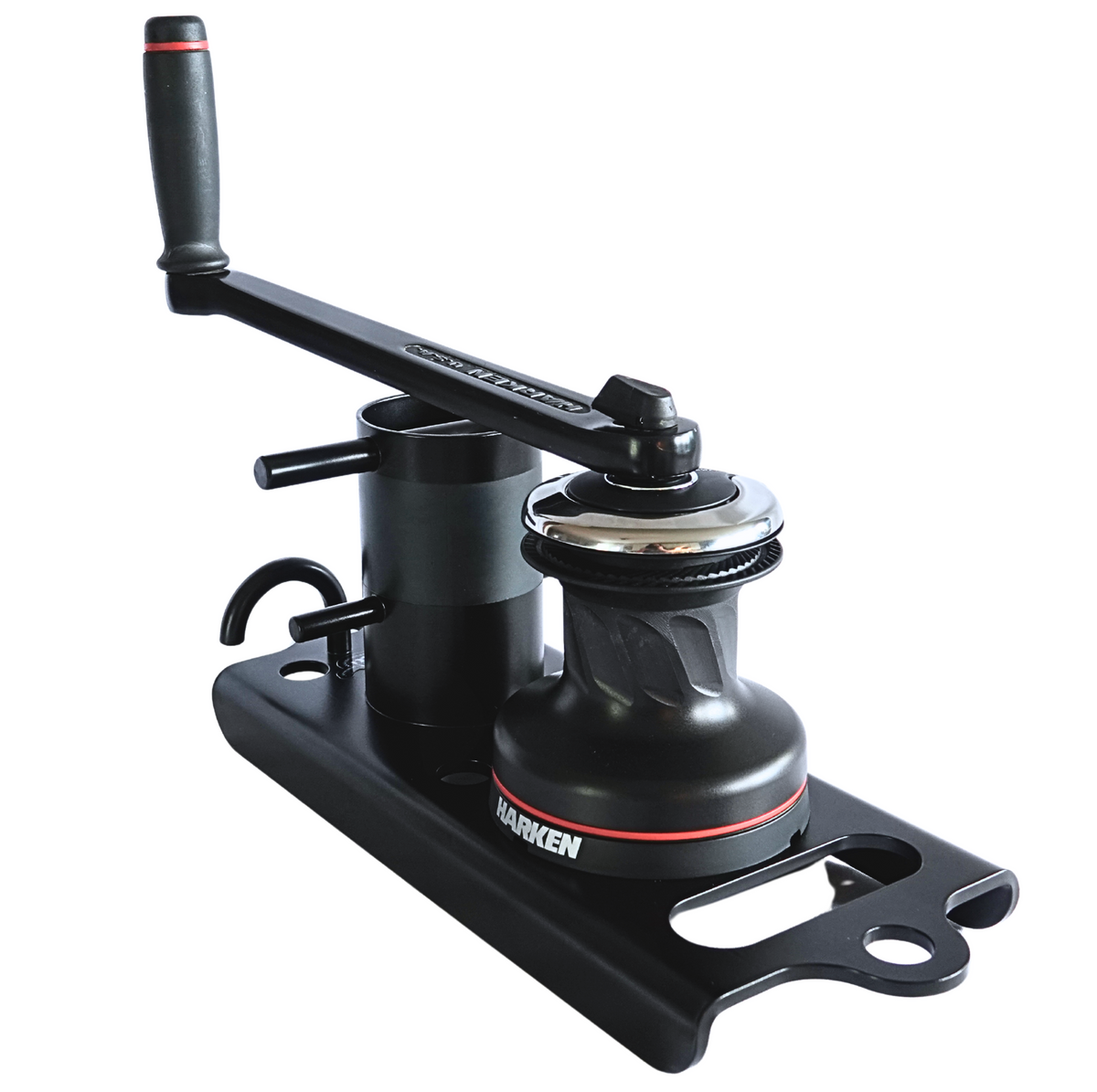 A black Harken marine winch and mounting base kit, featuring a manual crank handle, winch body, and mounting plate, shown on a solid white background.