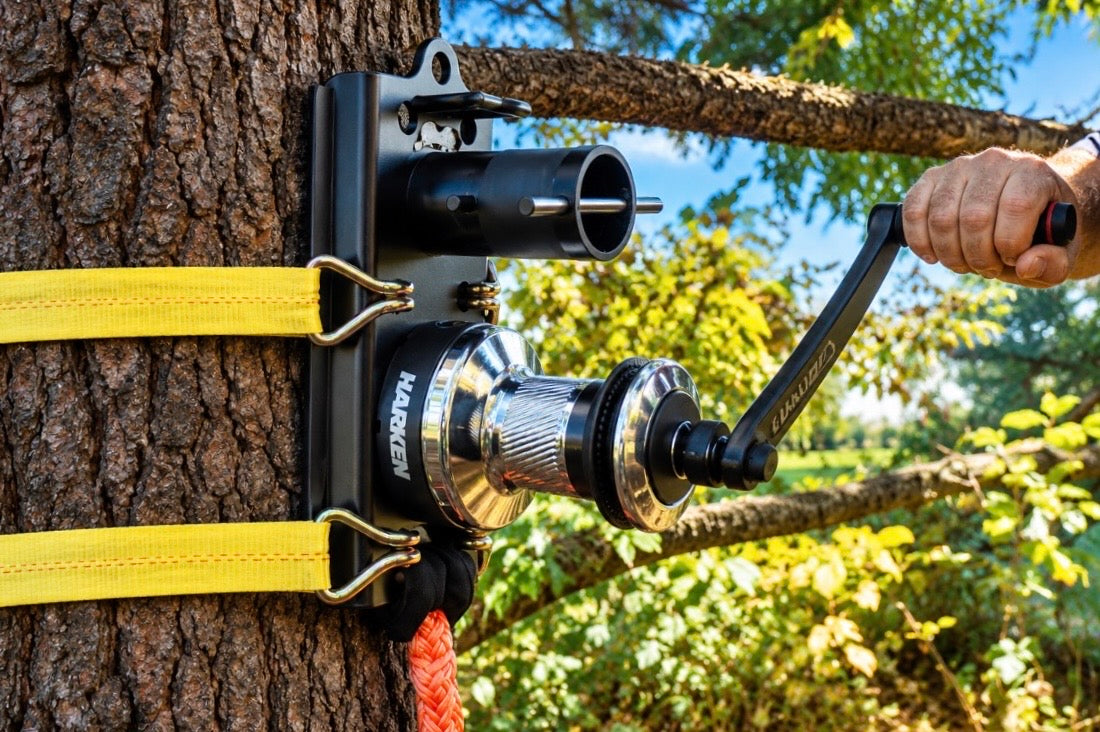 Hold Fast XL Rigging System mounted to tree with man using handle